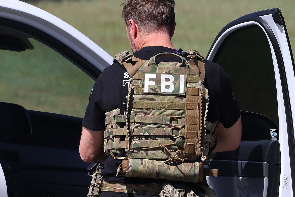 An FBI agent prepares to help with the response on Canfield Mountain on Sunday.