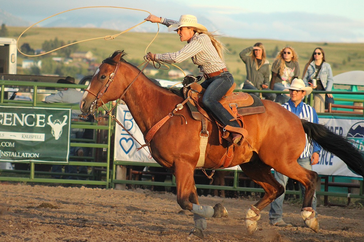 Breakaway roper lunges for a calf during last Friday's Mission Mountain Rodeo in Polson. (Kaleb Unger/Leader)