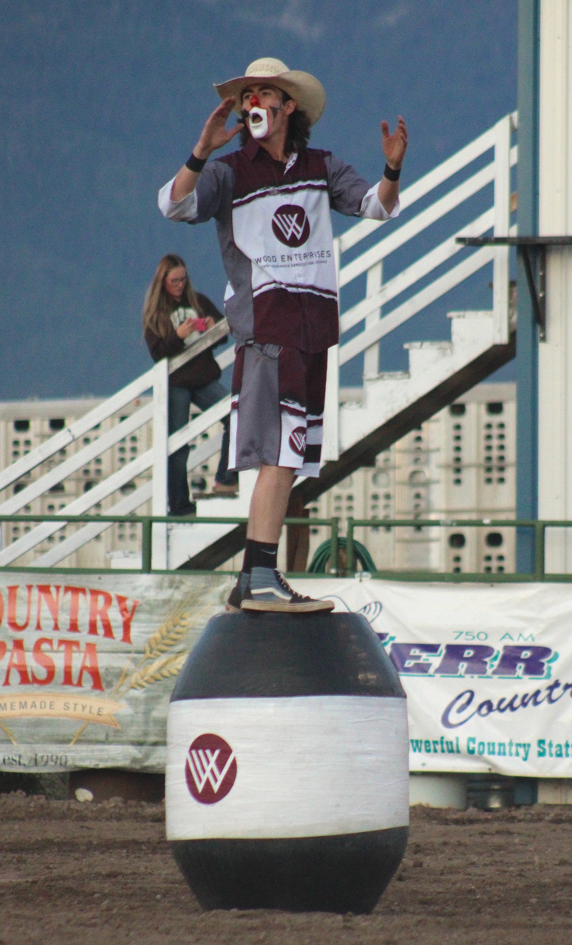 Rodeo clown – ready to dive into his barrel at any moment – gets the audience on their feet during the Mission Mountain Rodeo. (Kaleb Unger/Leader)