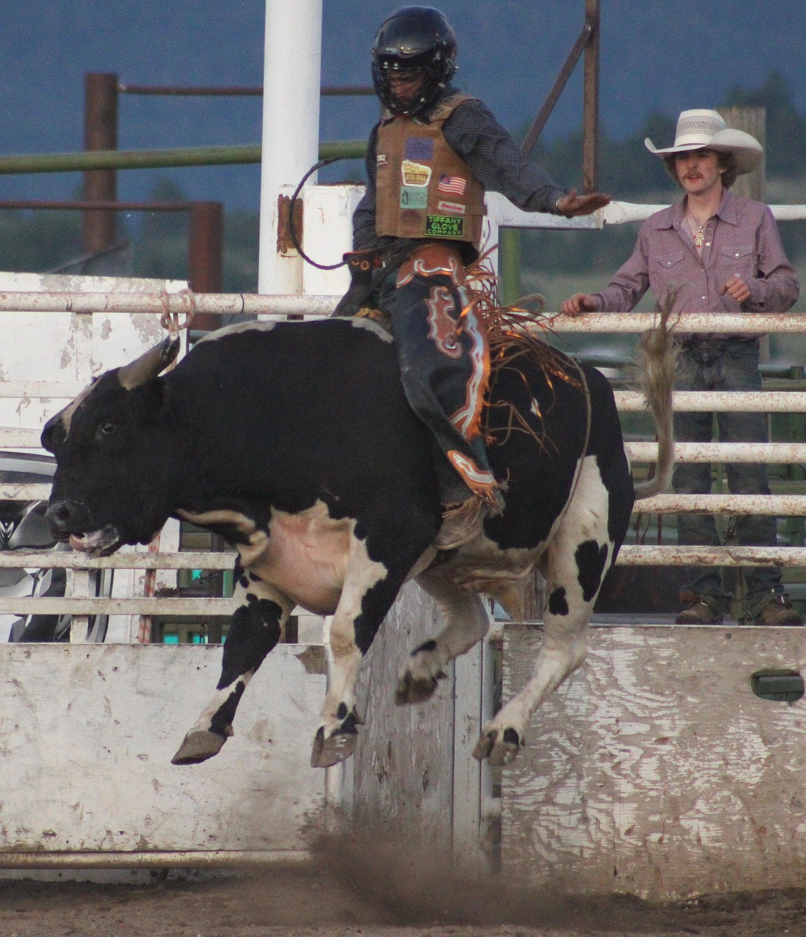 Bull takes flight straight out of chute as its rider attempts to hold on for those precious eight seconds. (Kaleb Unger/Leader)