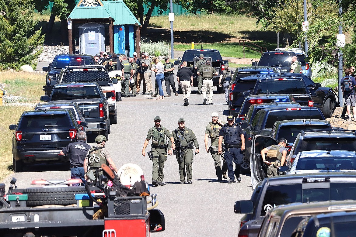 Law enforcement officers stage at Cherry Hill Park next to Canfield Mountain on Sunday in Coeur d'Alene, Idaho. (Bill Buley/CdA Press)