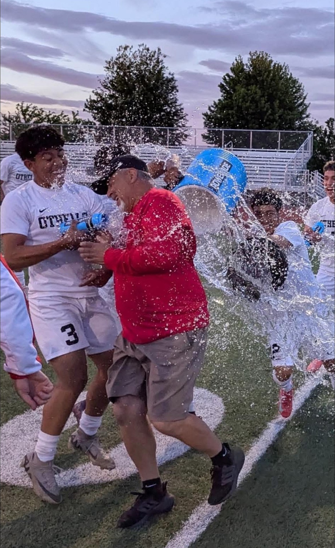 Huskies head soccer coach Bernie Garza takes a Gatorade bath after winning the district championship against Grandview.