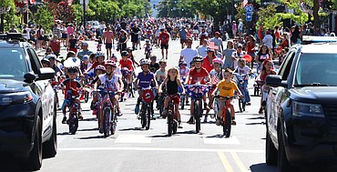Coeur d'Alene police escort hundreds of kids down Sherman Avenue for the annual Kiddie Parade on Thursday.