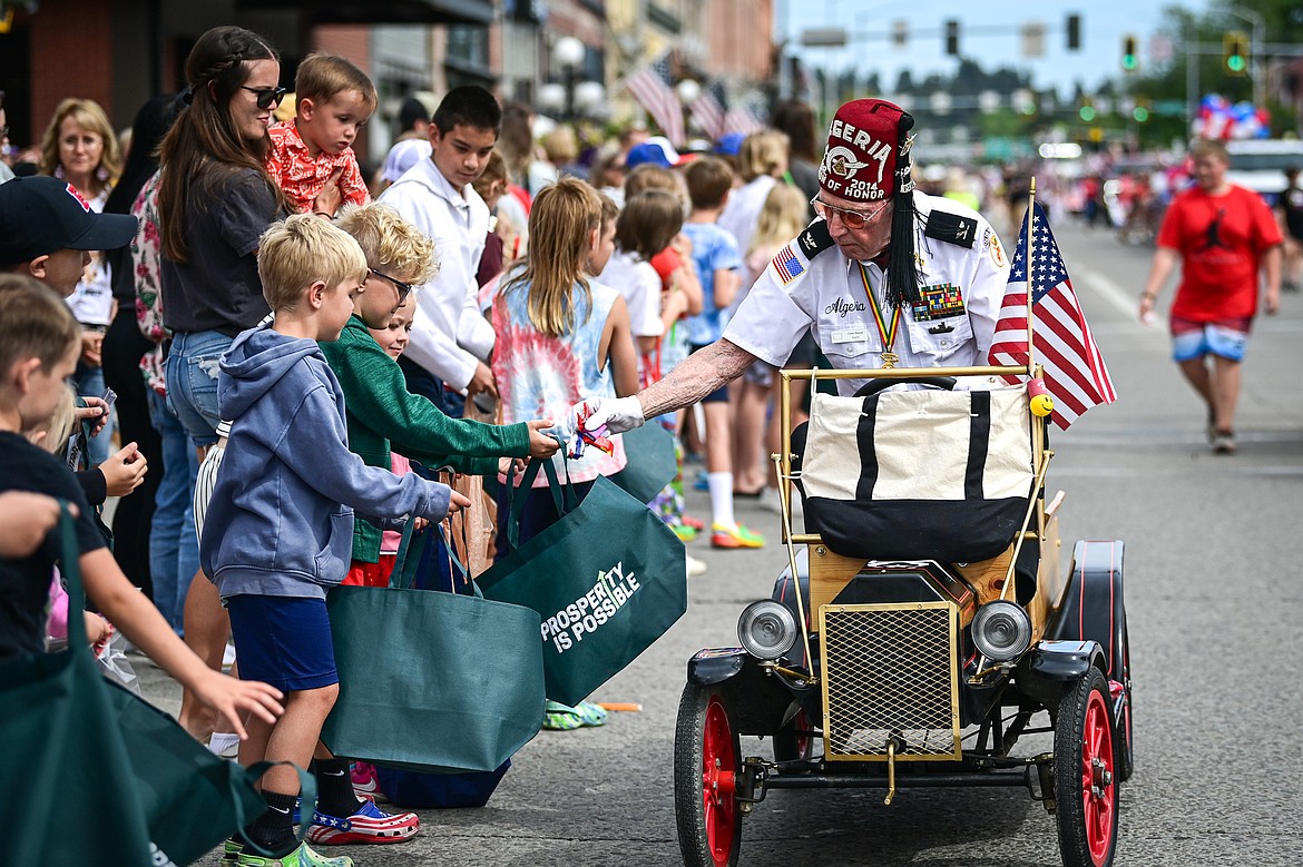 Gene Hawes of the Flathead Shrine Club hands out candy in the Kalispell 4th of July Parade on Friday, July 4. (Casey Kreider/Daily Inter Lake)