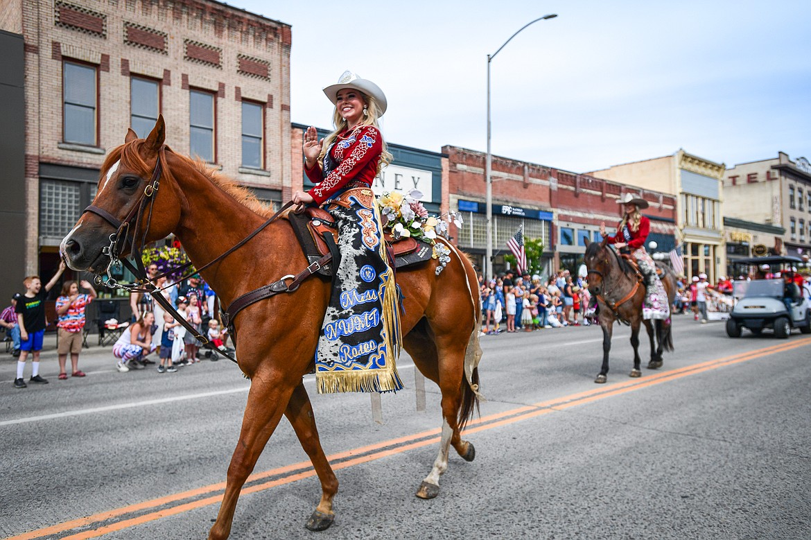 Two MIss Northwest Montana Rodeo winners ride horses down Main Street in the Kalispell 4th of July Parade on Friday, July 4. (Casey Kreider/Daily Inter Lake)