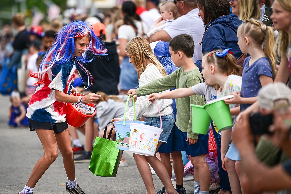 A young girl hands out candy in the Kalispell 4th of July Parade on Friday, July 4. (Casey Kreider/Daily Inter Lake)