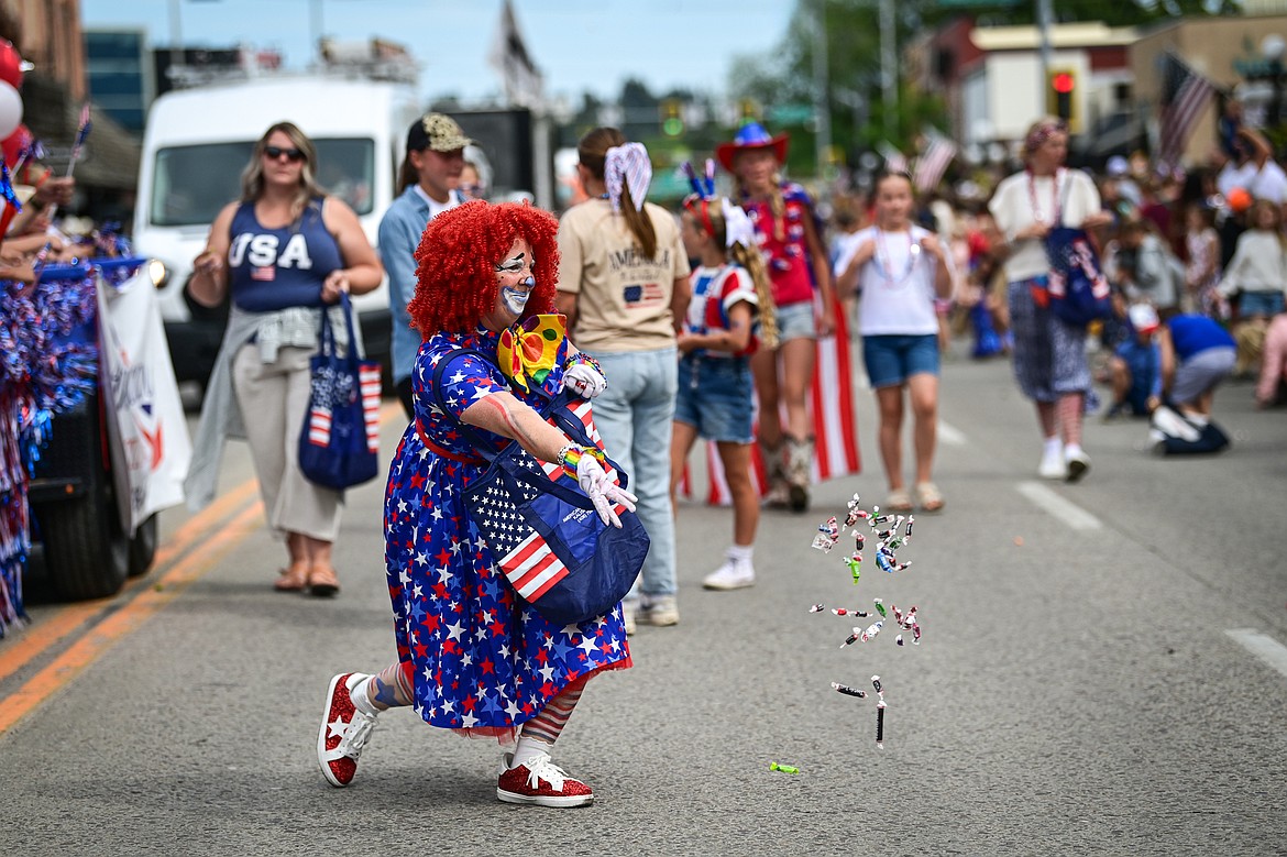A participant tosses candy in the Kalispell 4th of July Parade on Friday, July 4. (Casey Kreider/Daily Inter Lake)