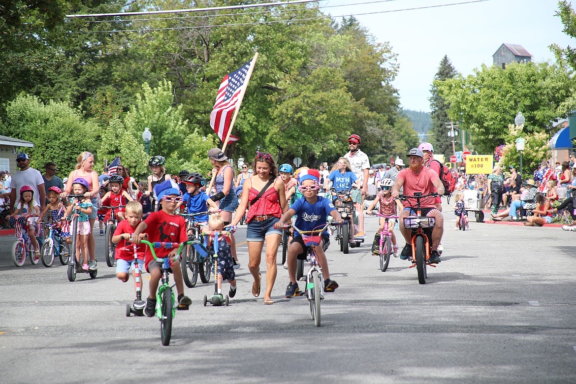 Local youth make their way down Church Street during the Sandpoint Lions Fourth of July kids parade.