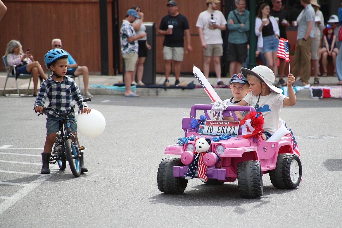 Local youth take part in the Sandpoint Lions kids parade on the Fourth of July on Friday.