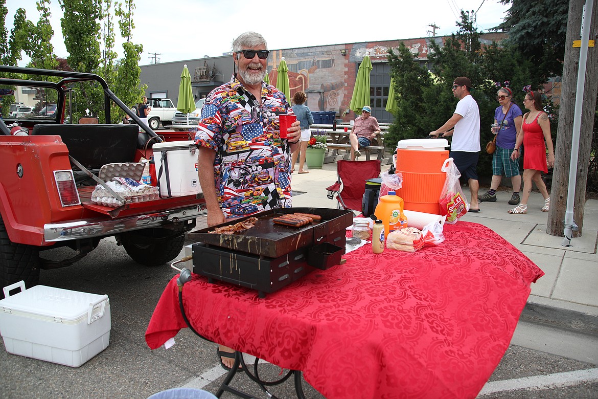 Boomer Baker grins as he cooks up hotdogs while tailgating at the Sandpoint Lions Fourth of July parades.