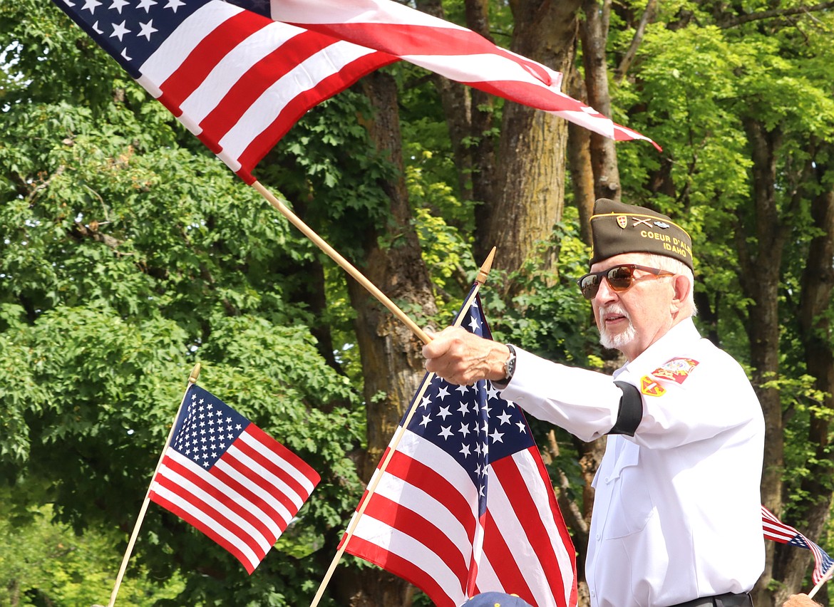 Veteran Dave Collier waves a flag in the Fourth of July parade in Coeur d'Alene.