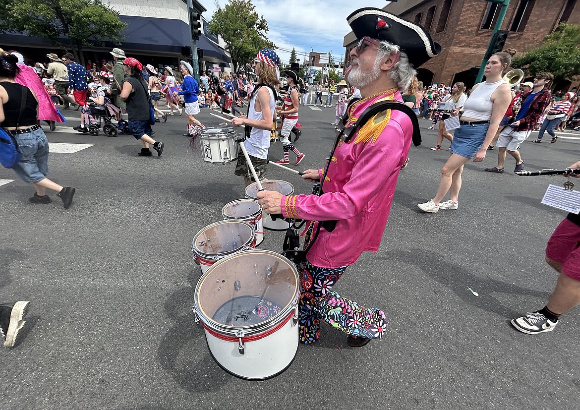 Steven Polunsky with the Forget Me Nots plays the drums in the Fourth of July parade on Sherman Avenue.