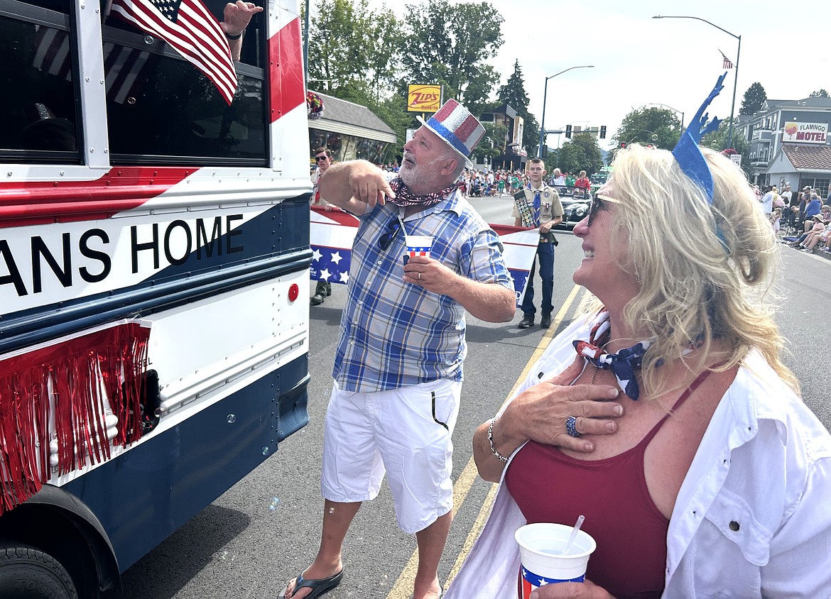Mario and Brenda Spangenberg wave to a van with veterans, including Brenda's dad.