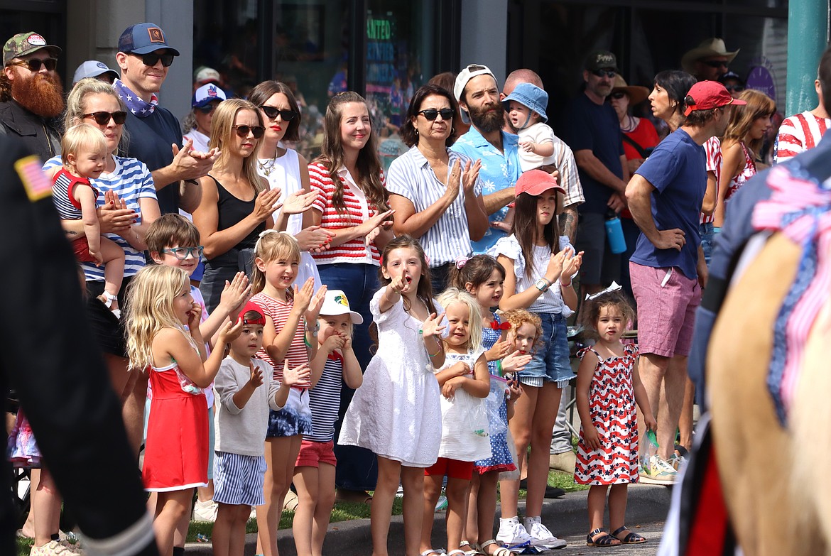 The crowd watches first responders and families pass by during the parade.
