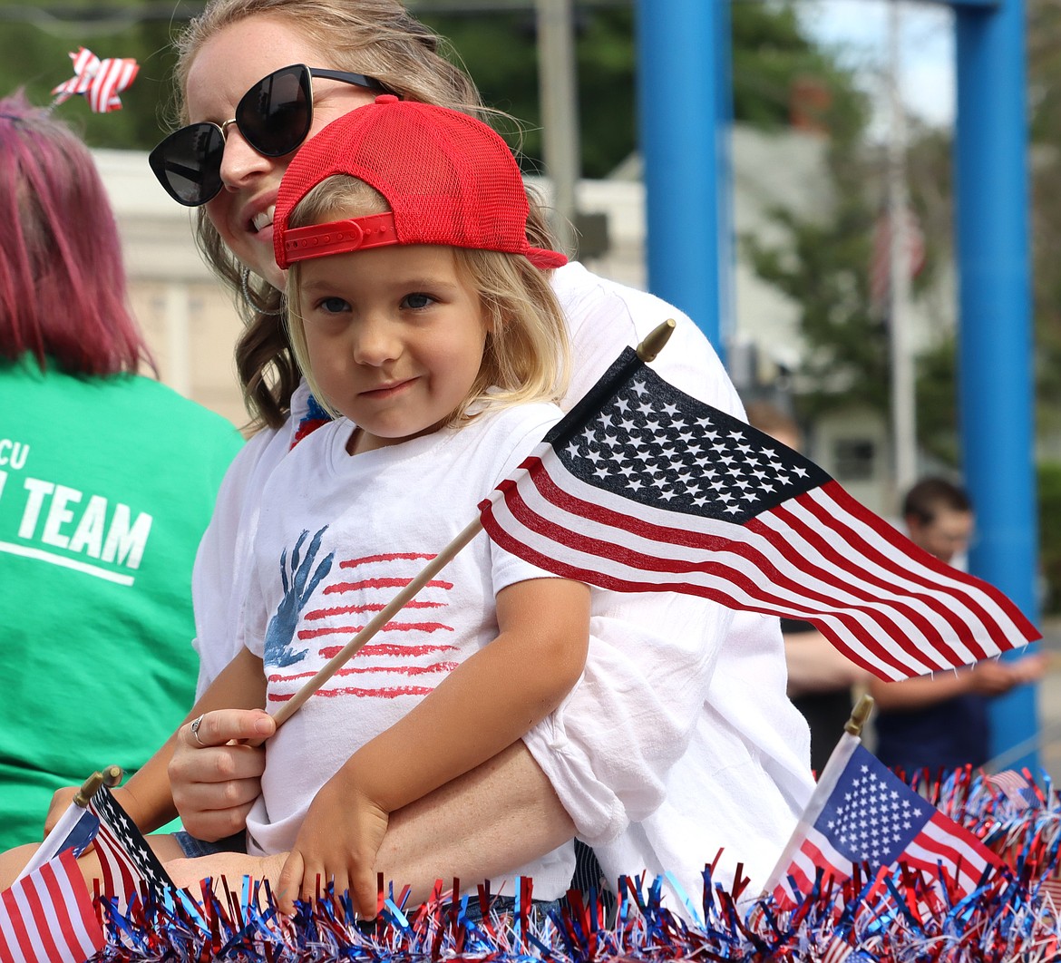 Sydnee and Merrik Ramsey-Rivas ride the ICCU Fourth of July parade entry.
