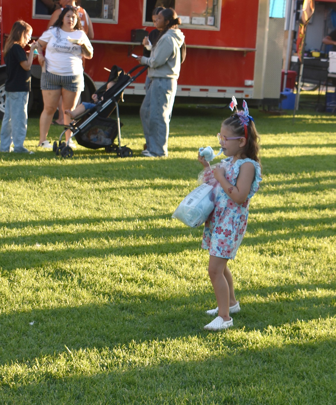 Shyla Young-Settles, 4, enjoys some cotton candy at Red, White and Boom in Moses Lake.