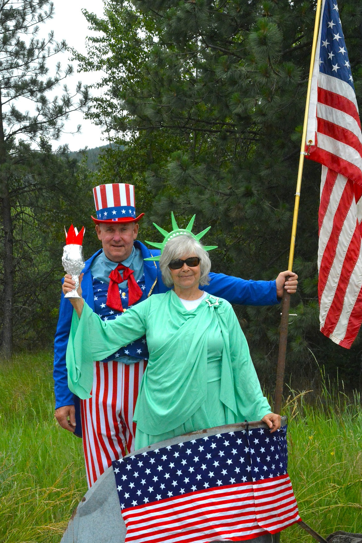Lady Liberty and Uncle Sam hitched a chariot ride behind one of the antique tractors in the St. Regis 4th of July parade. (Mineral Independent/Amy Quinlivan)
