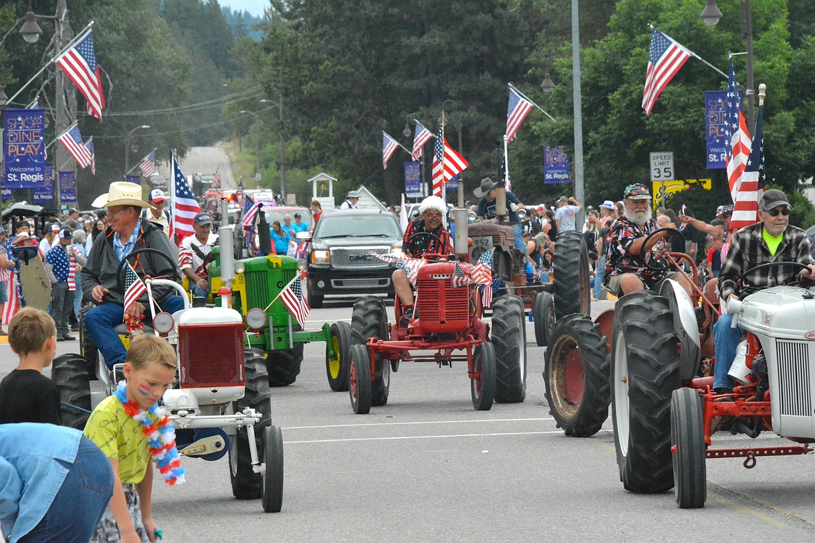 The vintage tractor brigade is a fan favorite, decorated side by sides, walking groups, and kids on bikes made up the long array of parade entries. (Mineral Independent/Amy Quinlivan)