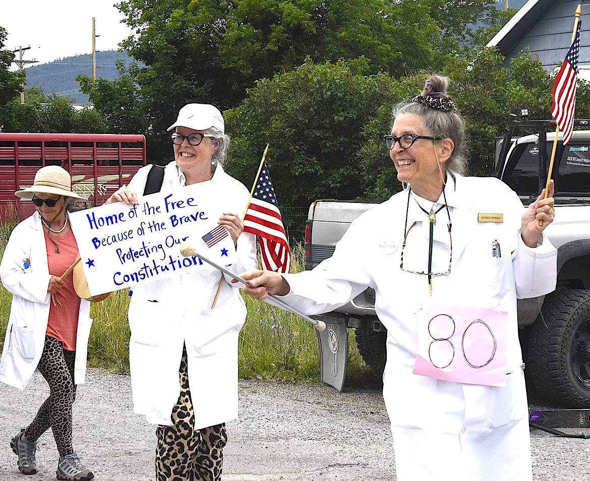 Science Women walked in the Arlee Fourth of July Parade wearing white coats and leopard print, and urging the crowd to "protect our Constitution." (Berl Tiskus/Leader)