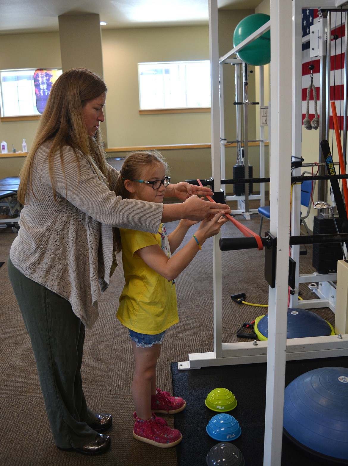 Stephanie Morrison gets Erika Bledsoe ready for an exercise Monday at North Idaho Physical Therapy in Hayden.