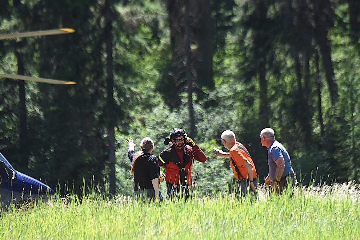 Flathead Search and Rescue's Darren Wise, second from left, celebrates a safe landing Sunday, June 29, 2025, with David Thompson Search and Rescue members Valerie Albert, Dick Balcom and Jon Obst during a training rendezvous at Fawn Creek Campground. (Scott Shindledecker/The Western News)