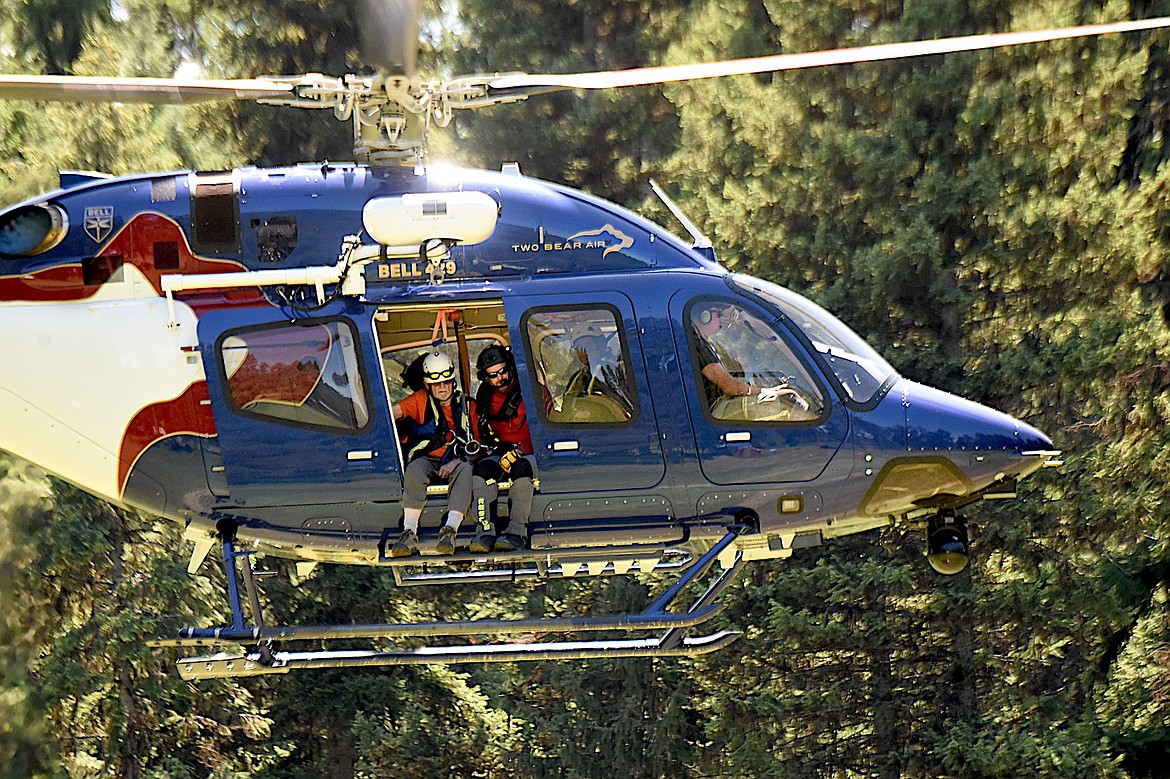 Flathead Search and Rescue's Darren Wise, right, and David Thompson Search and Rescue members Dick Balcom get ready to land Sunday, June 29, 2025, during a training rendezvous at Fawn Creek Campground. (Scott Shindledecker/The Western News)