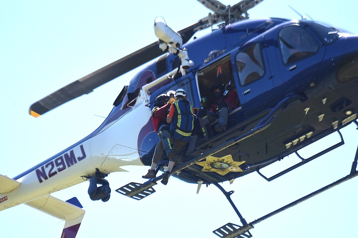 Flathead Search and Rescue's Darren Wise, left, and David Thompson Search and Rescue member Dick Balcom are hoisted into a 2 Bear Air helicopter Sunday, June 29, 2025, during a training rendezvous at Fawn Creek Campground. (Scott Shindledecker/The Western News)