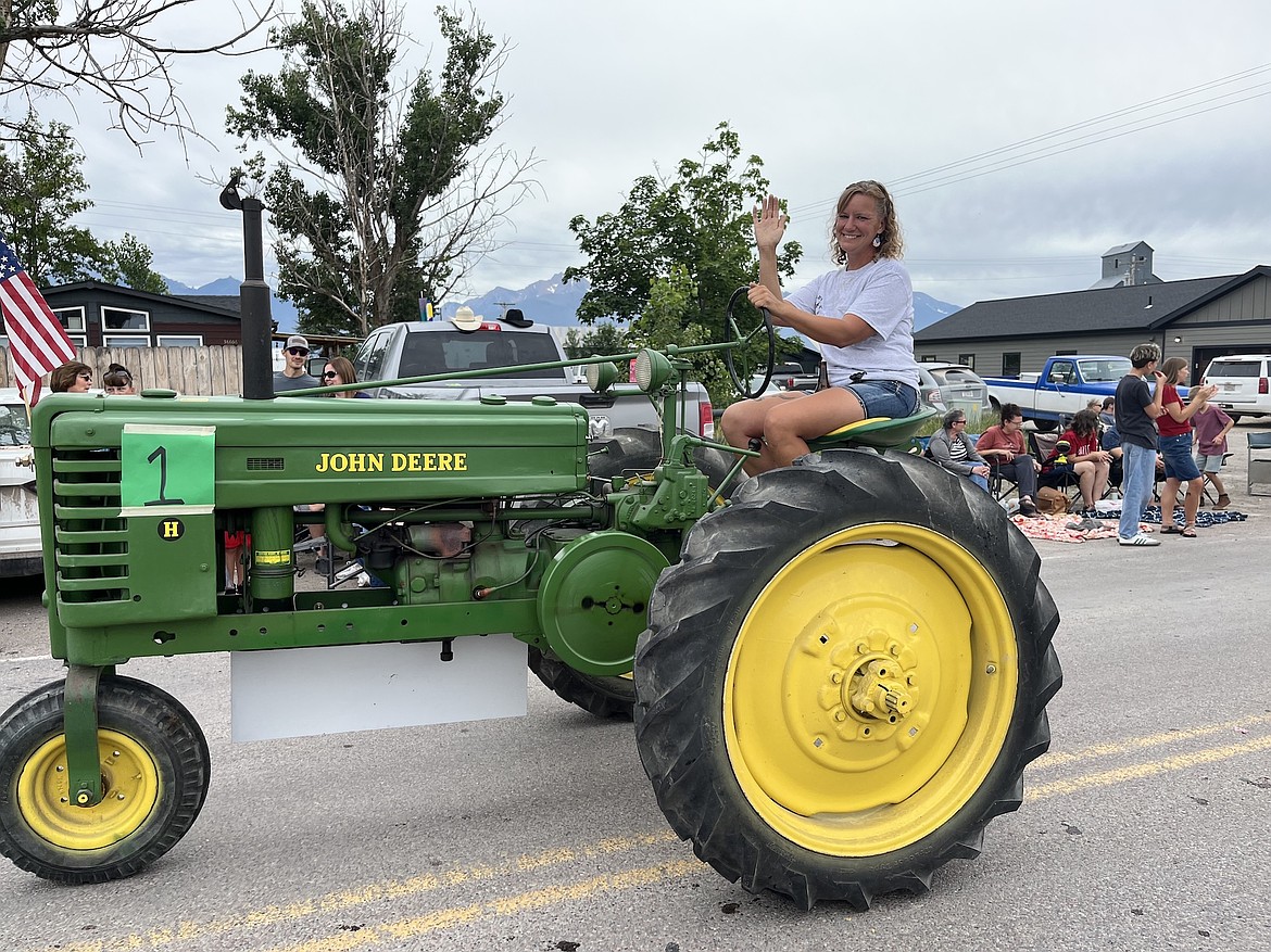 Bonnie Clark piloted a John Deere H tractor through Charlo Friday on behalf of B & D's Bounty Parts. (Kristi Niemeyer/Leader)