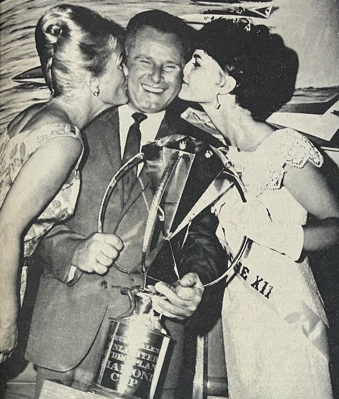 Driver Bill Brow of Miss Exide was kissed by his wife, Faye, left, and Miss Coeur d’Alene XII Sue Wolden after winning the Diamond Cup in 1965.