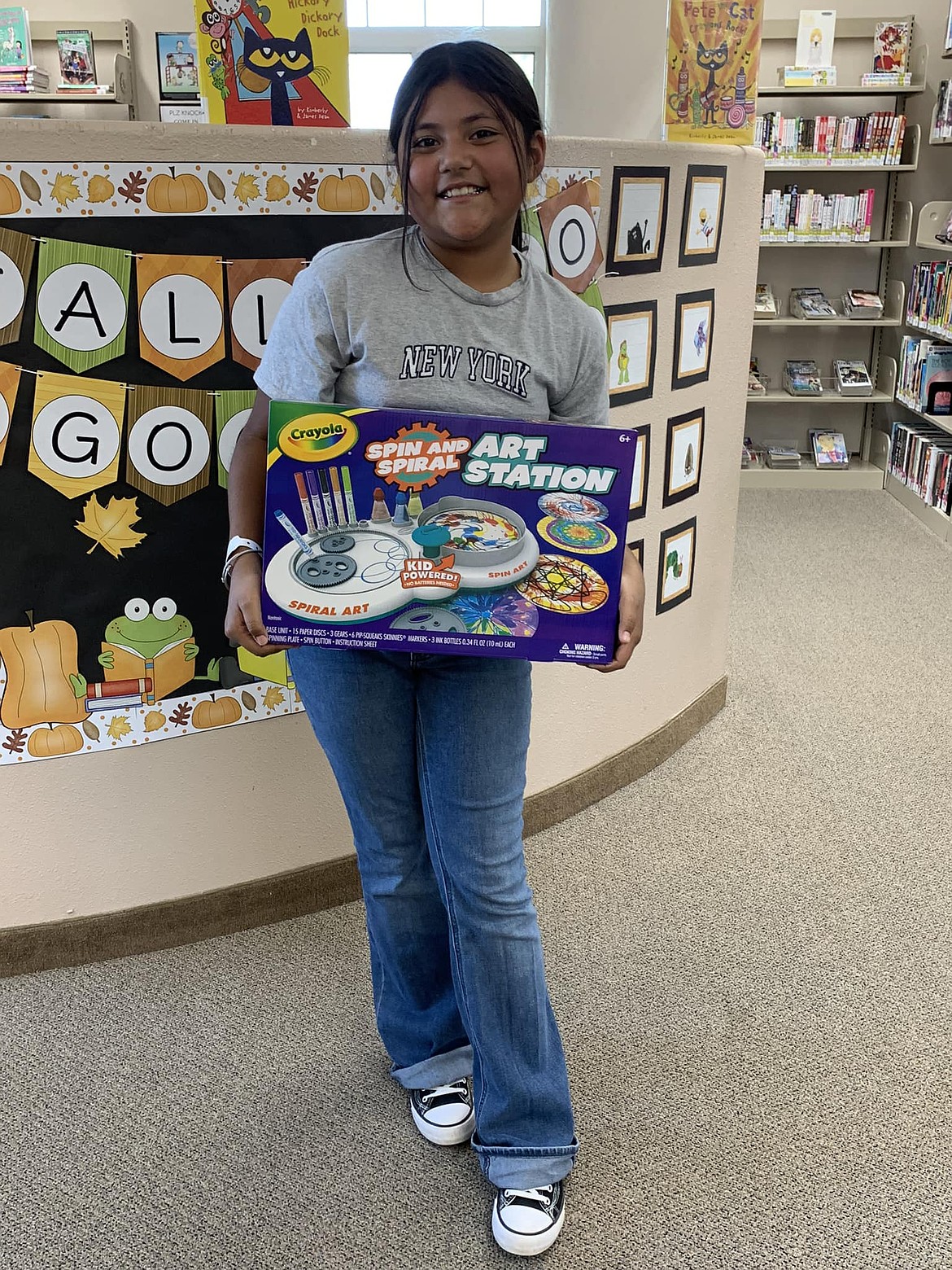 One of the winners for the 2024 summer reading program in Mattawa displays her prize. The 2025 summer reading program is among the activities going on now at the Mattawa library.