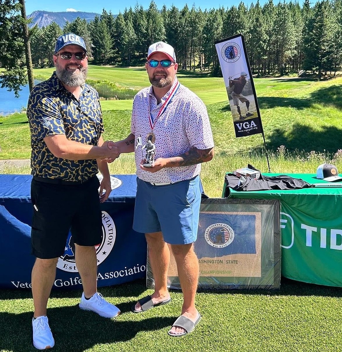 Nick Nesmith with Veteran Golfers Association’s Washington Assistant Director Jeffery Wheatcroft after winning his state championship. Nesmith said this was his first state championship win, but he holds higher aspirations for a national championship.