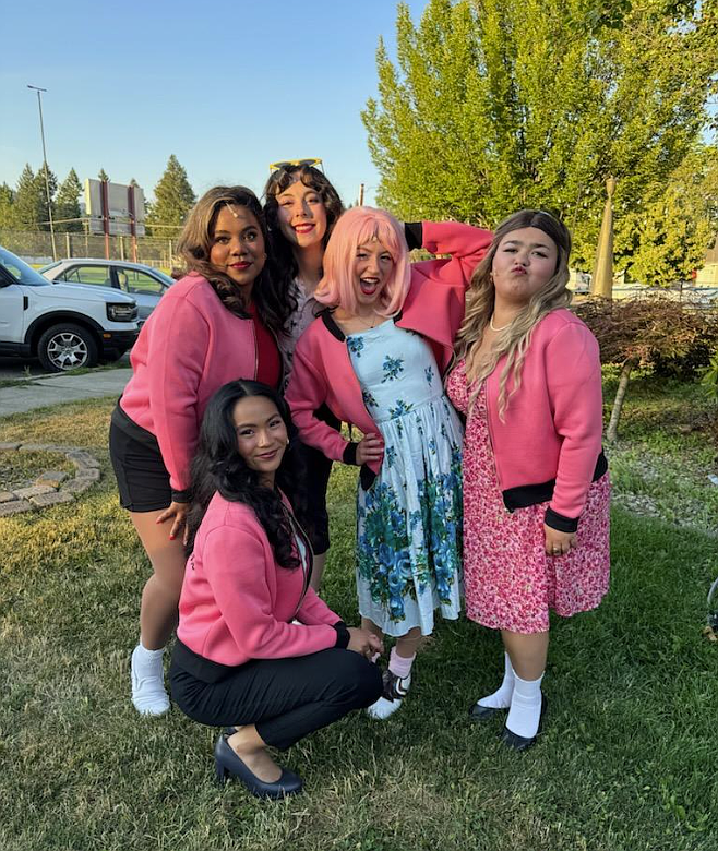 The Pink Ladies recreate a photo pose from when Lake City Playhouse brought "Grease" to the stage in 1997. The 2025 production opens tonight. Standing, from left: Josi Brett as Rizzo, Zoey Evens as Jan, Juno Otis as Frenchy and Lorelai Provolt as Sandy. Front: Stevie Austidillo as Marty.