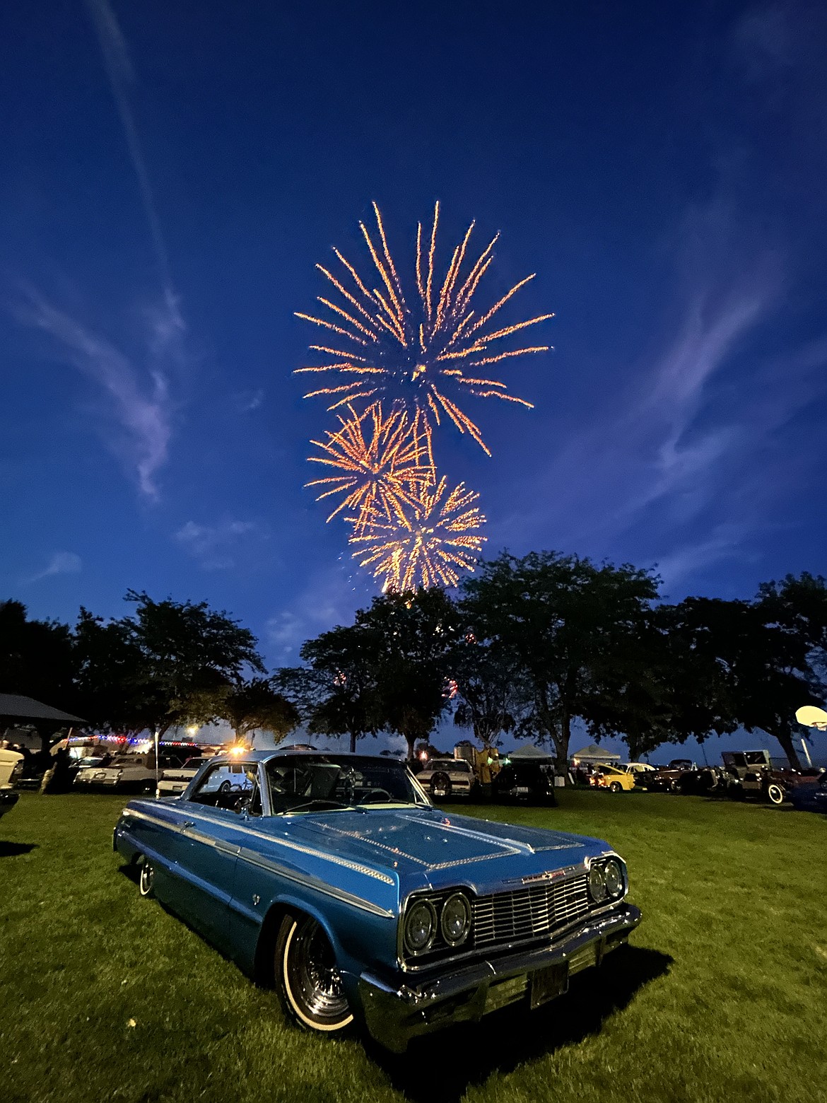Fireworks decorate the sky above the Headlights and Summer Nights Car Show in Royal City July 11.