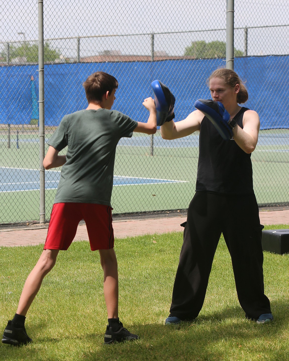 Freewind Martial Arts instructor Jacob Guertin, right, helps Ethan Young, left, with striking during Friday’s seminar. Guertin said he likes to adjust his teaching style to everyone’s learning style.
