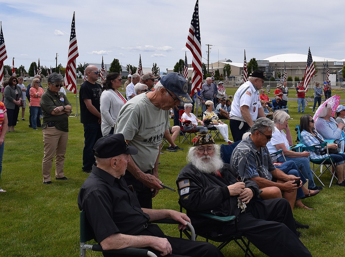 Veterans sit or stand at the cemetery in Quincy for a Memorial Day ceremony in 2024. While accessing the American Legion or Veterans of Foreign Wars organizations is relatively easy in Grant County, U.S. Department of Veterans Affairs services have become more challenging to access this year as budget cuts at the state and national level along with staffing cuts at the VA have caused challenges and other delays.