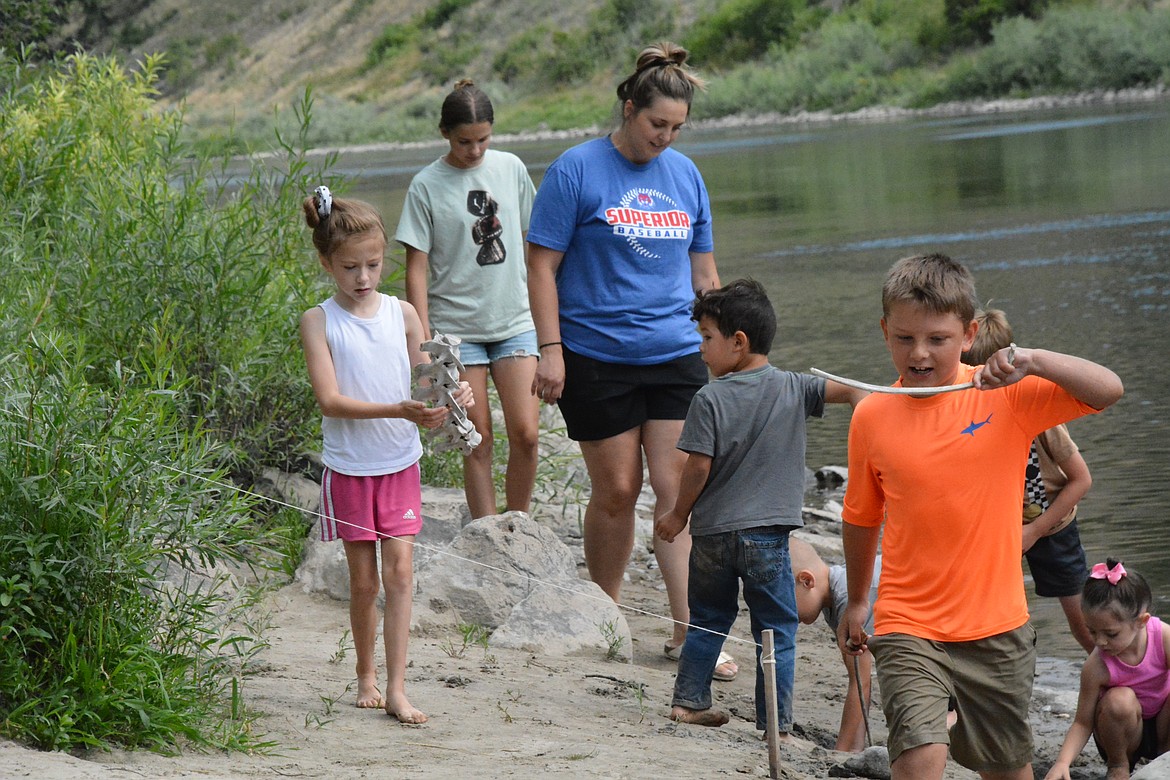 MJ Allard, in orange, thought his rib bone looked more like a mustache bone. (Mineral Independent/Amy Quinlivan)