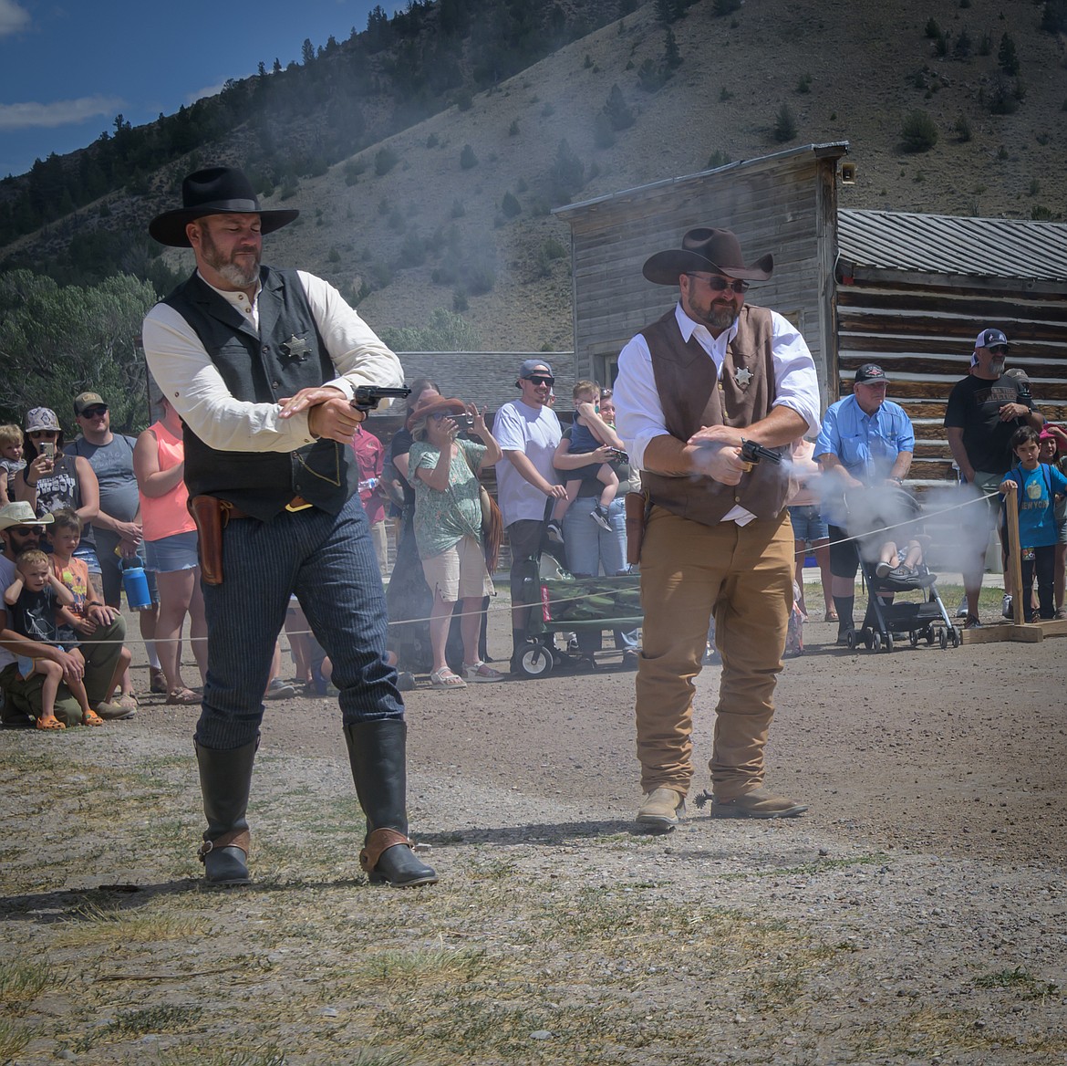 Bannack lawmen sheriff Josh Mellott from Gardiner, left, and deputy Fred Eckley, also from Gardiner, go up against the criminal element during a shootout on Main Street during Bannack Days. (Tracy Scott/Valley Press)