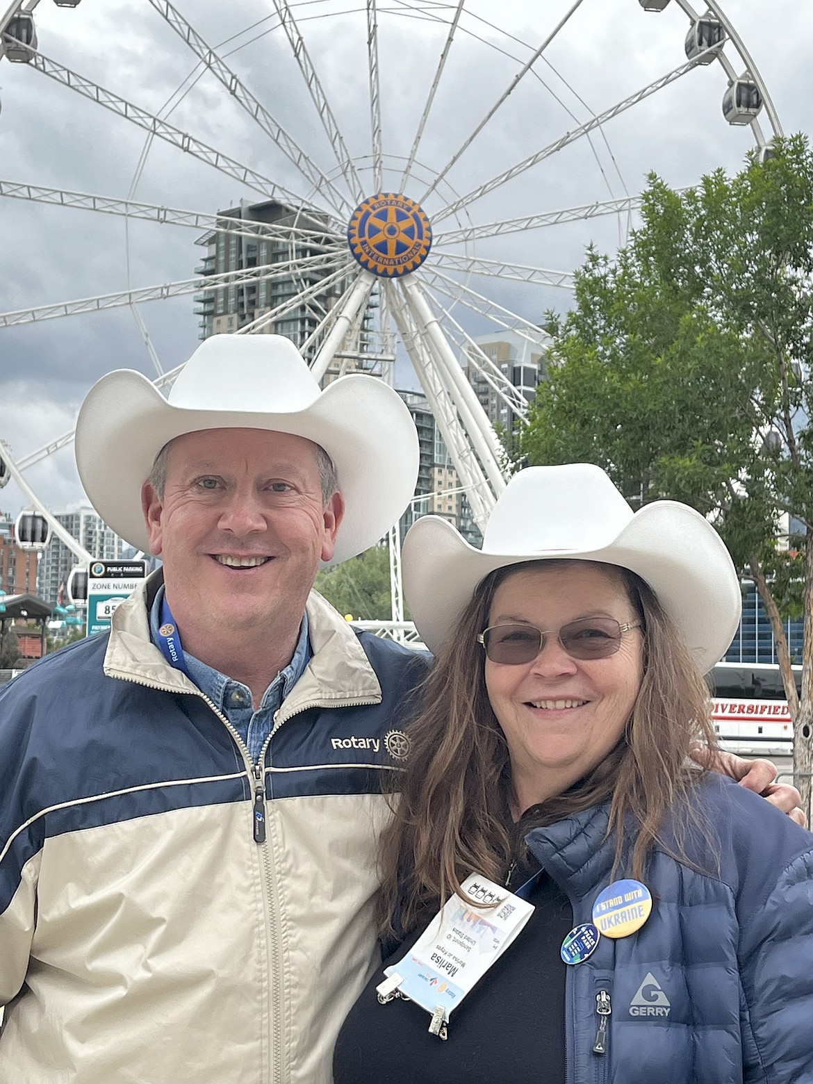 David and Marlisa Keyes stop for a moment in front of a Ferris wheel in Calgary at Rotary's International Conference.