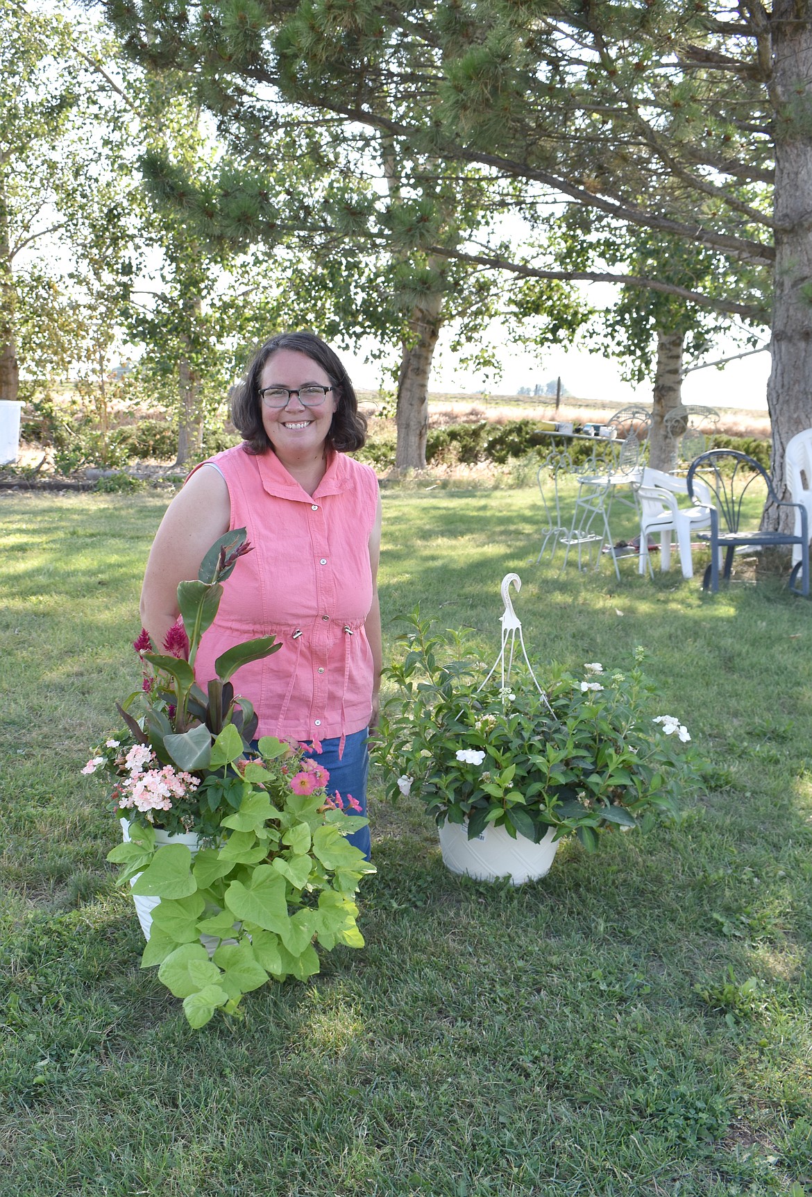 Valerie Parrott, president of the Columbia Basin Garden Club, shows a couple of her flower arrangements for fair display.
