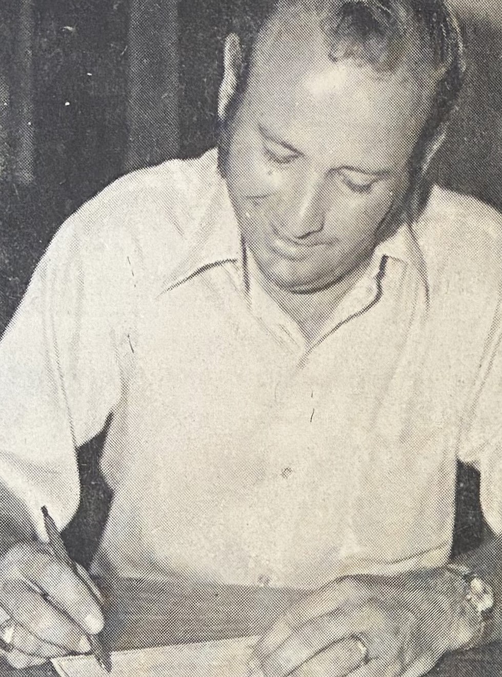 Mayor Ron Edinger signs a $195,000 check as final city payment for 34 acres of Tubbs Hill in 1975.