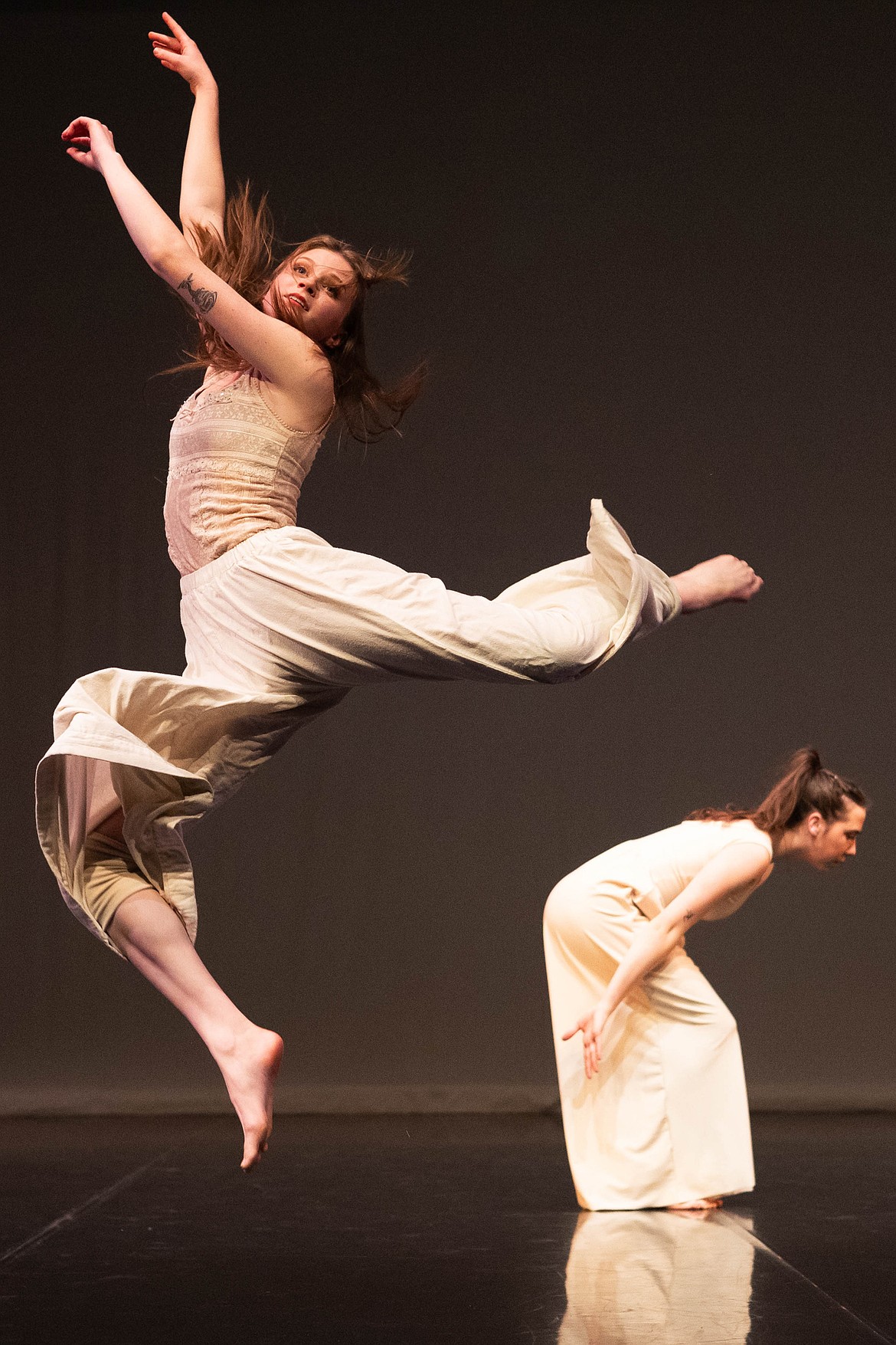 Ferguson, left, leaps into the air during UM's American College Dance Association Benefit Concert. (UM Photo by Ella Palulis)