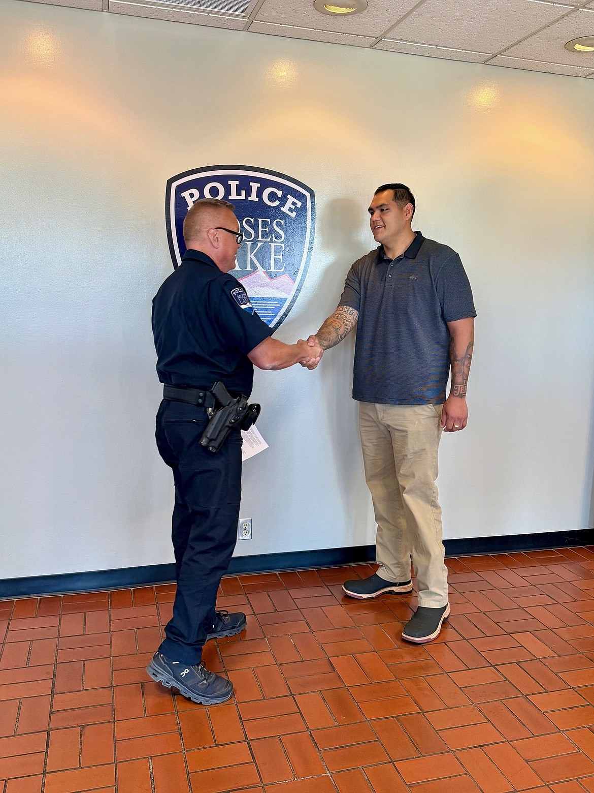 Moses Lake Police Department Chief Dave Sands, left, shakes hands with Cesar Sandoval, right, the newest MLPD officer.
