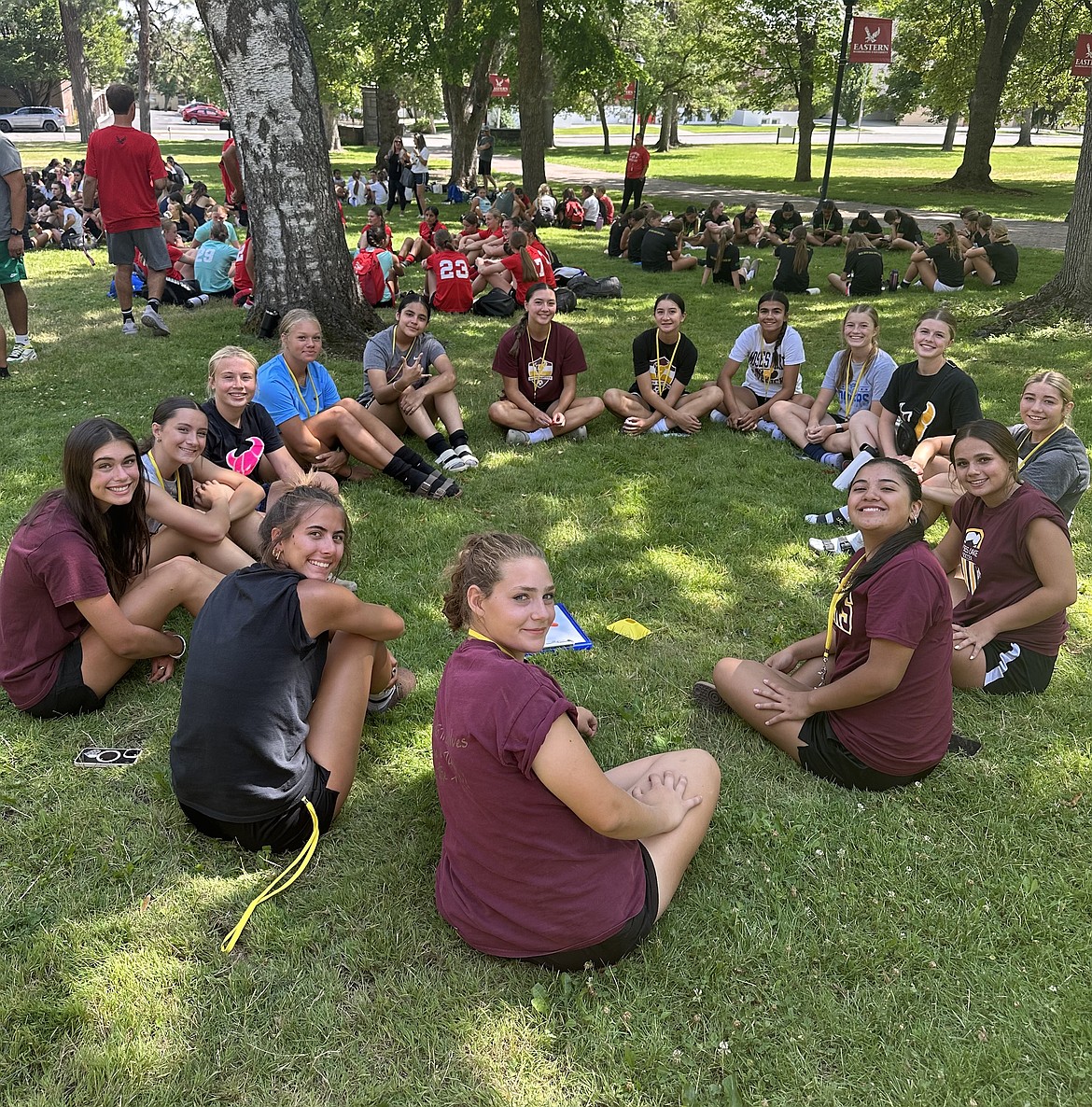 Mavericks players sit around in a circle on the EWU campus with other teams at the camp doing the same. In between scrimmage matches the girls would also participate in team bonding exercises.