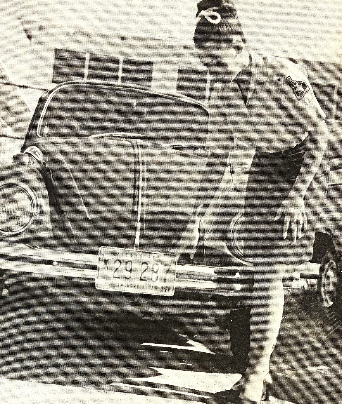 Beverly Lieder, an Idaho State Police employee, points to the digit that traffic cops check for proper auto registration in 1970.