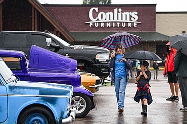 Attendees check out rows of classic and custom vehicles at the Evergreen Show 'N Shine at Conlin's Furniture on Saturday, Aug. 2. (Casey Kreider/Daily Inter Lake)