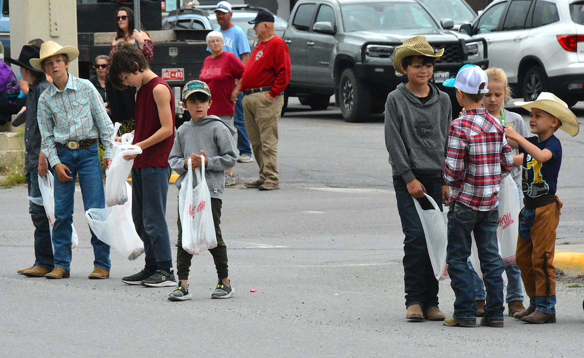 Boys in cowboy boots and cowboy hats await the parade lineup. (Mineral Independent/Amy Quinlivan)