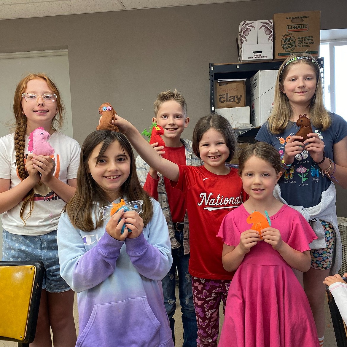 Children show off the creations they’ve made in an Old Hotel art class this summer.