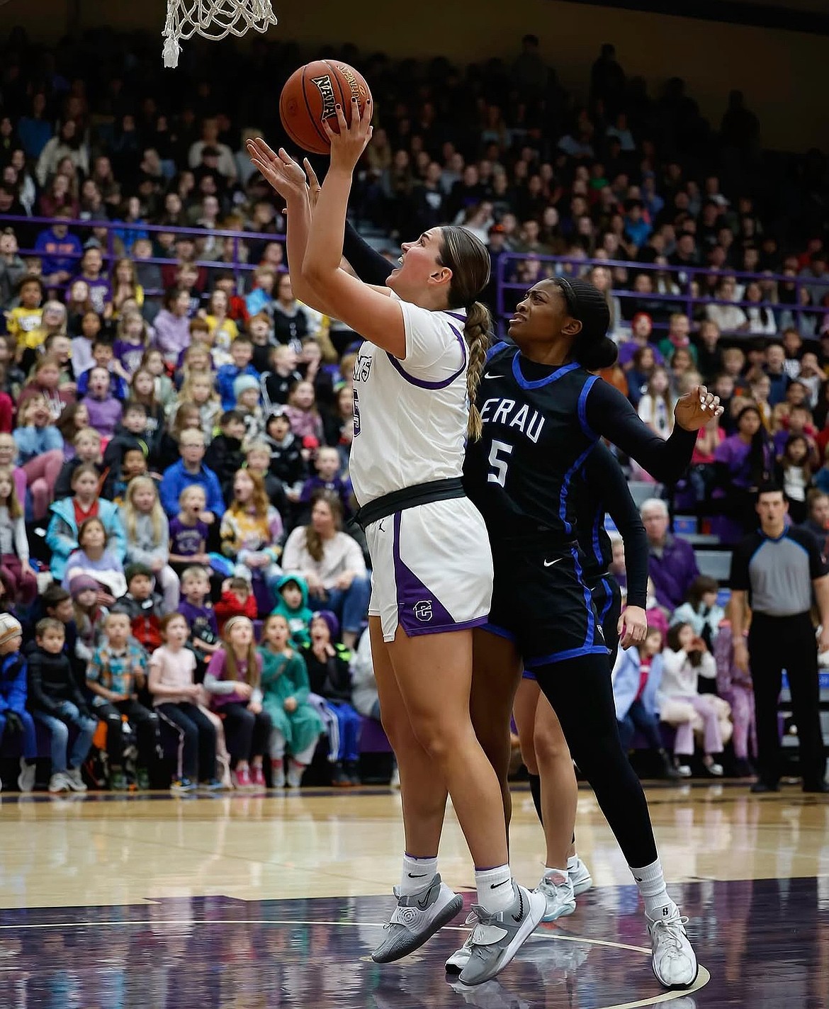 Meagan Karstetter, a senior at Carroll College, puts up a layup under pressure in a game last season. Karstetter said she hopes to become a team captain this season with the Fighting Saints.
