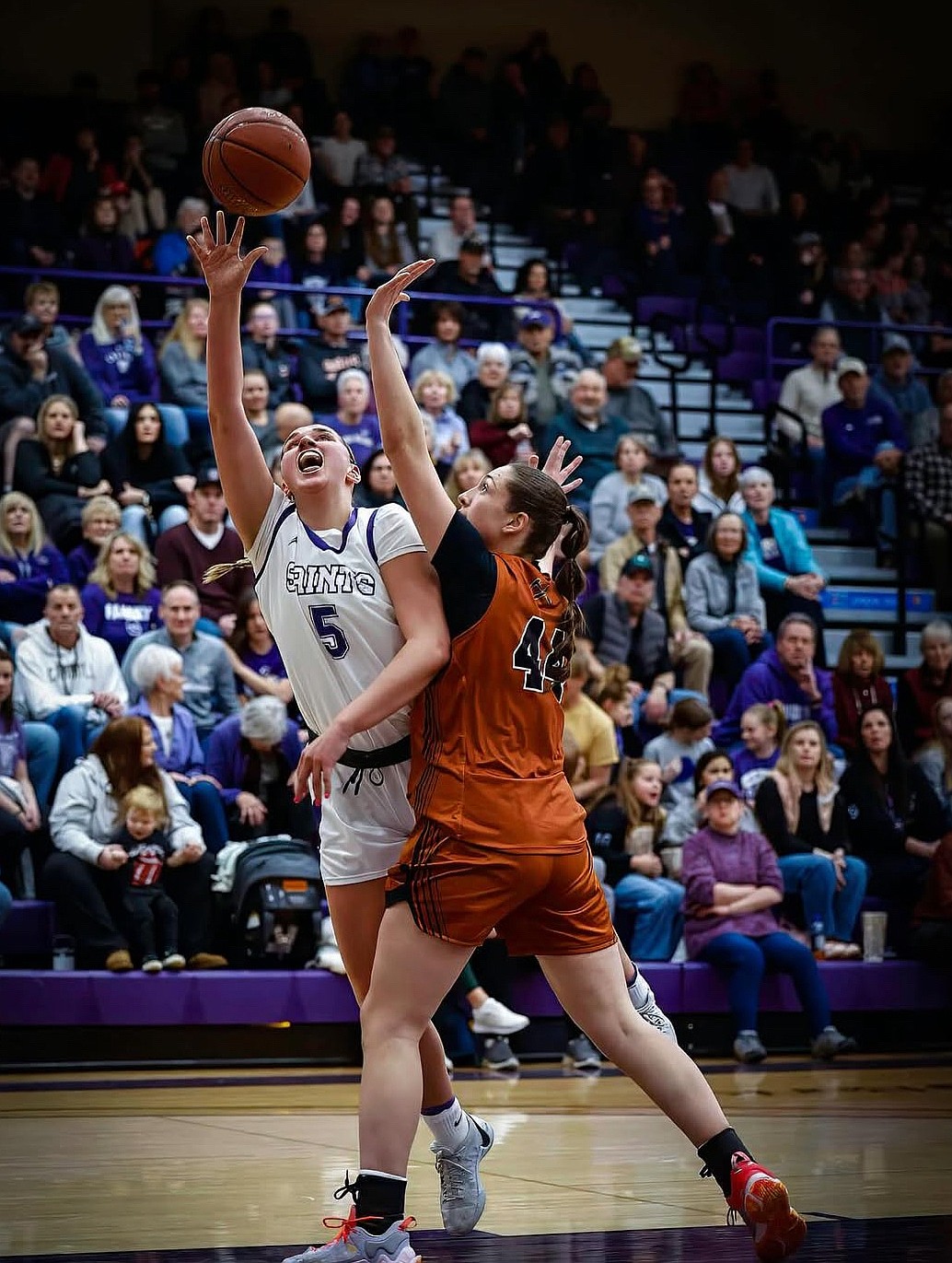 Fighting Saints senior Meagan Karstetter puts up a contested shot in a previous game last season. Karstetter said she loves to play physical, and welcomes contact from opponents during games.