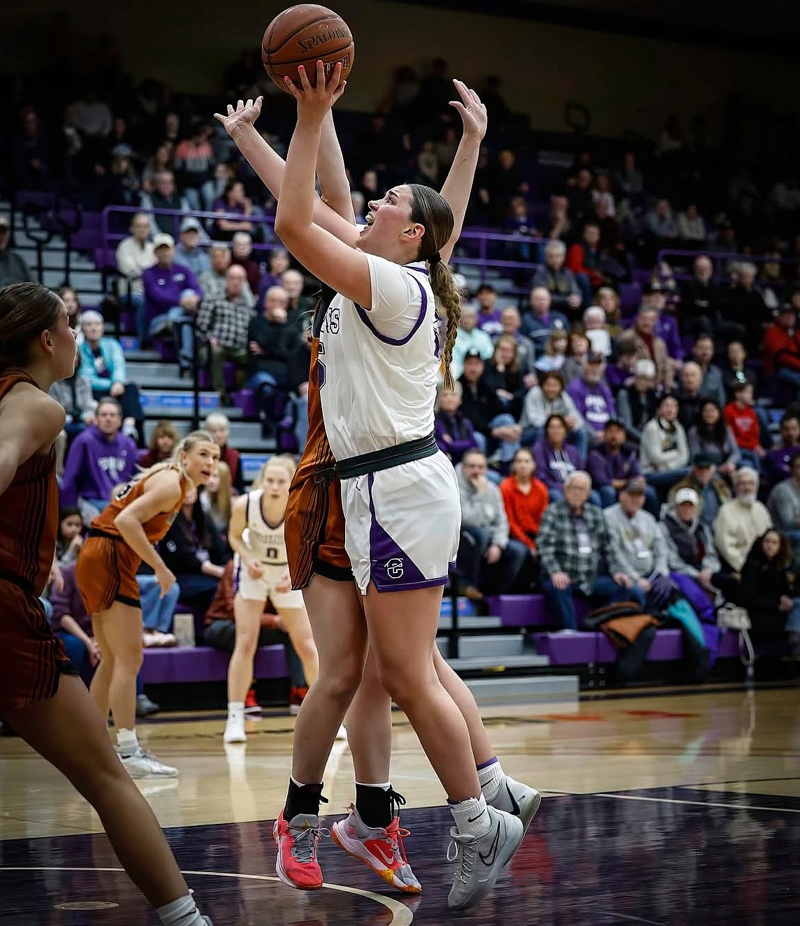 Meagan Karstetter, a senior for the Fighting Saints, floats a shot up under pressure in a game last season. Lindsey Moore, a former trainer for Karstetter, said she pays attention to the details of basketball, calling it one of her biggest strengths.